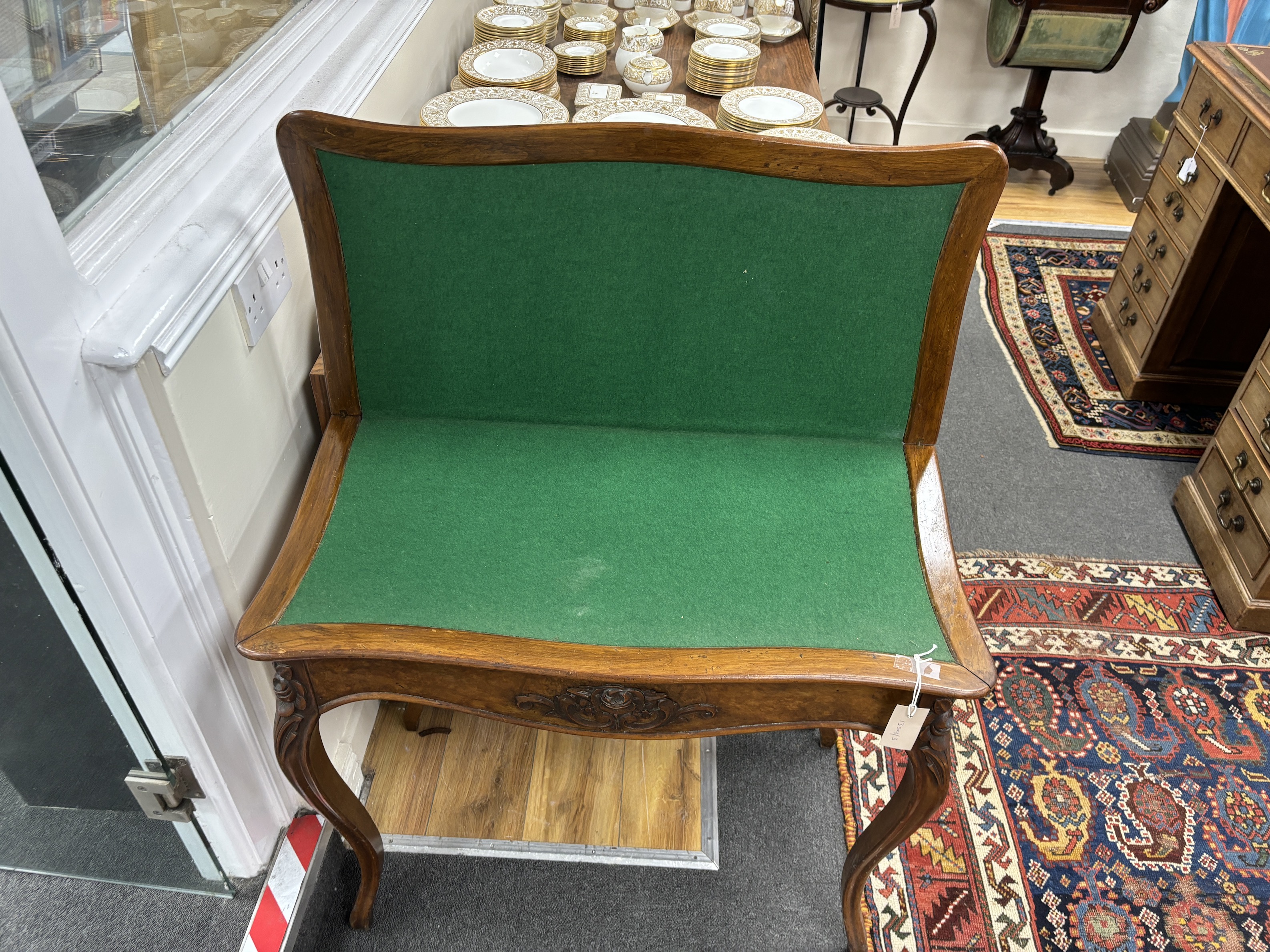 A Victorian walnut serpentine folding card table, width 80cm, depth 40cm, height 73cm.